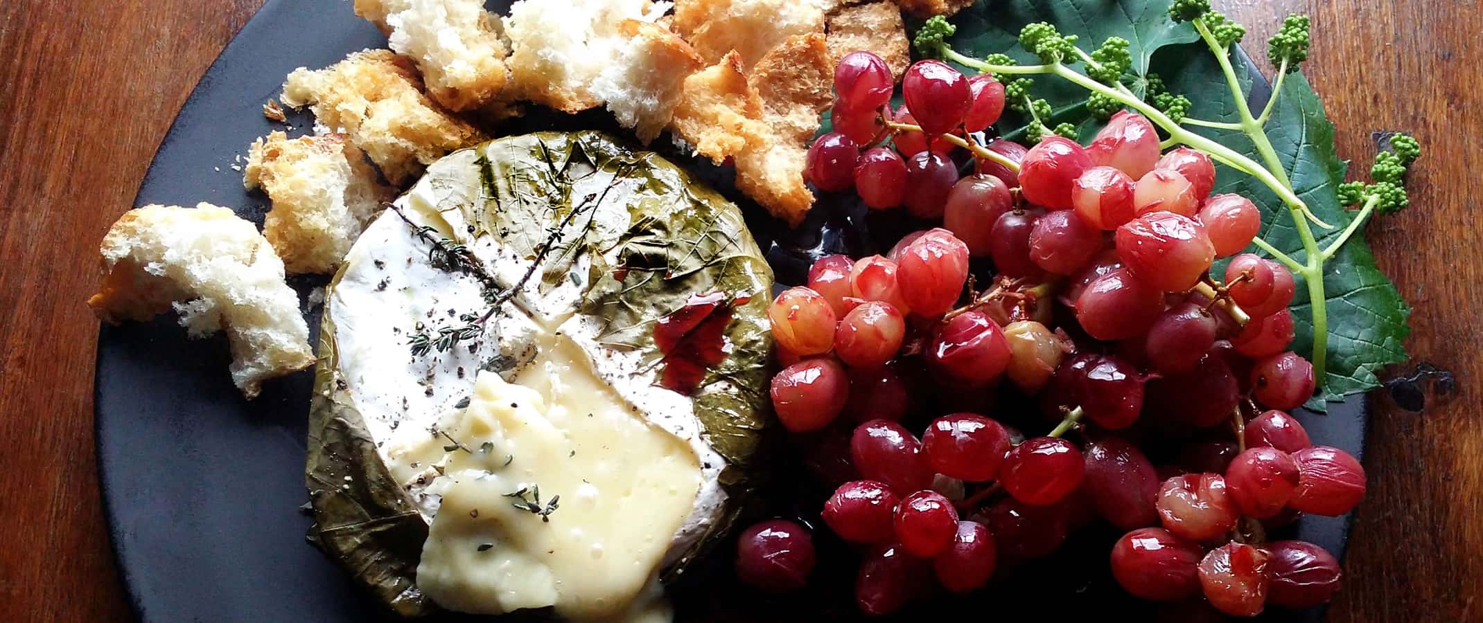 Camembert Roasted in Vine Leaves with Verjuice-Poached Grapes